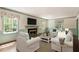 Bright living room with a fireplace, large windows, and elegant decor at 400 Bowling Creek Rd, Chapel Hill, NC 27514