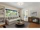 Cozy living room featuring built-in bookshelves, comfortable seating, and large windows with a view at 400 Bowling Creek Rd, Chapel Hill, NC 27514
