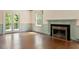 Spacious living room with fireplace, hardwood floors, and French doors to outdoor balcony at 400 Bowling Creek Rd, Chapel Hill, NC 27514