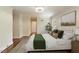 Cozy main bedroom featuring a comfortable bed with green accents, carpet, and a window with natural light at 400 Bowling Creek Rd, Chapel Hill, NC 27514