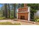 Outdoor brick fireplace with a view of the lake and surrounding trees at 409 W Holding St, Smithfield, NC 27577