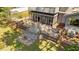 Aerial view of backyard deck with patio, screened porch, second-story balcony, and lush green landscaping at 409 W Holding St, Smithfield, NC 27577