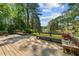 Wooden backyard deck overlooking a serene lake, surrounded by lush trees at 409 W Holding St, Smithfield, NC 27577