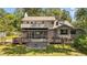 View of home and backyard featuring large deck, screened porch, and second-story balcony at 409 W Holding St, Smithfield, NC 27577