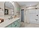 Stylish bathroom with marble vanity, arched mirror, and a shower with a shower curtain at 409 W Holding St, Smithfield, NC 27577