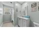 Well-lit bathroom with a shower-tub combination, white vanity, and framed mirror at 409 W Holding St, Smithfield, NC 27577