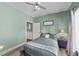 Cozy bedroom with neutral paint, plush carpet, and a comfortable bed and ceiling fan at 409 W Holding St, Smithfield, NC 27577
