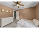 Cozy bedroom featuring neutral walls, ceiling fan, and soft carpet flooring at 409 W Holding St, Smithfield, NC 27577