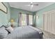 Cozy bedroom with neutral paint, plush carpet, and a comfortable bed and ceiling fan at 409 W Holding St, Smithfield, NC 27577