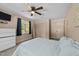 Bright bedroom with soft blue accents, carpet, and a ceiling fan at 409 W Holding St, Smithfield, NC 27577