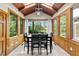 Dining area filled with natural light, beautiful wood panels, and picturesque lake views at 409 W Holding St, Smithfield, NC 27577