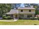 Charming two-story home with a stone facade and well-manicured front lawn at 409 W Holding St, Smithfield, NC 27577