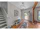 Inviting foyer with hardwood floors, staircase, and stylish light fixture at 409 W Holding St, Smithfield, NC 27577