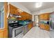 A functional kitchen featuring wood cabinets, stainless steel appliances, and plenty of counter space at 409 W Holding St, Smithfield, NC 27577