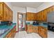 View of kitchen with wooden cabinets and blue counters, perfect for cooking and entertaining at 409 W Holding St, Smithfield, NC 27577