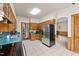Traditional kitchen with wooden cabinets, tile flooring, and modern stainless steel refrigerator at 409 W Holding St, Smithfield, NC 27577