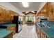 Bright kitchen featuring wooden cabinets, stainless steel appliances, and view to dining area at 409 W Holding St, Smithfield, NC 27577