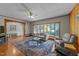Spacious living room with a bay window, hardwood floors, and a ceiling fan at 409 W Holding St, Smithfield, NC 27577