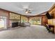 Inviting living room featuring a stone fireplace, wood paneling, and large windows for natural light at 409 W Holding St, Smithfield, NC 27577