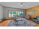 Comfortable living room with hardwood floors, bay window, and ceiling fan at 409 W Holding St, Smithfield, NC 27577