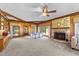 Spacious living room with wood paneling, stone fireplace, and abundant natural light at 409 W Holding St, Smithfield, NC 27577