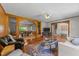 Open-concept living room with hardwood floors, detailed trim work, and a TV at 409 W Holding St, Smithfield, NC 27577