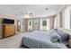 Comfortable main bedroom with ensuite bathroom, ceiling fan, and bright windows providing relaxing backyard views at 409 W Holding St, Smithfield, NC 27577