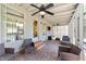 Inviting screened porch with a brick floor, ceiling fans, and comfortable seating at 409 W Holding St, Smithfield, NC 27577