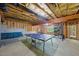 Spacious basement area with ping pong table, gym equipment, and ample space for recreation at 415 Waverly Hills Dr, Cary, NC 27519