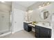 Bright bathroom with double vanities, a glass enclosed shower, and a serene, minimalist design at 415 Waverly Hills Dr, Cary, NC 27519