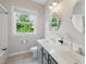 Bright bathroom featuring a double vanity with modern fixtures and a large window at 415 Waverly Hills Dr, Cary, NC 27519
