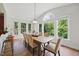 Bright breakfast nook featuring large windows, natural light, and a farmhouse table with seating for six at 415 Waverly Hills Dr, Cary, NC 27519