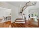 Elegant foyer with hardwood floors, a staircase, and views of the dining room at 415 Waverly Hills Dr, Cary, NC 27519