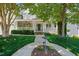 Charming home featuring a welcoming front porch, lush lawn, and mature trees at 415 Waverly Hills Dr, Cary, NC 27519