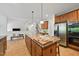 Modern kitchen showcasing a large center island with granite countertop and stainless steel refrigerator and oven at 415 Waverly Hills Dr, Cary, NC 27519