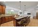Open kitchen featuring a large island with seating, granite countertops and seamless flow to the living spaces at 415 Waverly Hills Dr, Cary, NC 27519