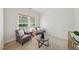 Cozy sitting room with neutral color scheme, comfortable armchairs, and lots of natural light from the window at 415 Waverly Hills Dr, Cary, NC 27519