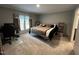 Cozy bedroom with neutral colors, a queen-sized bed and a comfortable workspace at 420 Spring Ln, Henderson, NC 27537