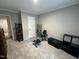 A carpeted bedroom with a door leading to other areas of the house with exercise equipment at 420 Spring Ln, Henderson, NC 27537