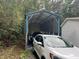 Large carport on the property featuring a full-size car and a pickup truck at 420 Spring Ln, Henderson, NC 27537