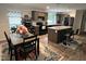 Modern kitchen and dining area with wood cabinets, a central island, and black appliances at 420 Spring Ln, Henderson, NC 27537