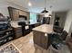 Modern kitchen with wood cabinets, a central island with bar stools, and black appliances at 420 Spring Ln, Henderson, NC 27537