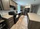 Modern kitchen with wood cabinets, gray countertops and black appliances at 420 Spring Ln, Henderson, NC 27537