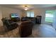 Inviting living room with a comfortable sectional sofa, recliner, and a large TV at 420 Spring Ln, Henderson, NC 27537