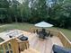 Expansive wooden deck featuring outdoor seating, a fire pit, and lush green backyard at 420 Spring Ln, Henderson, NC 27537