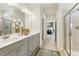 Modern bathroom with double sinks, gray cabinetry, and a glass-enclosed shower at 445 Olivia Crossing Ct # 22, Four Oaks, NC 27524