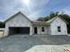 New construction home featuring a two car garage, visible studs and house wrap; ready for finishing at 445 Olivia Crossing Ct # 22, Four Oaks, NC 27524