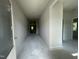 Bright hallway with neutral paint; ready for personalization and leading to various rooms at 445 Olivia Crossing Ct # 22, Four Oaks, NC 27524