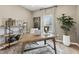 Inviting home office with a rustic wood desk, modern shelving, and large window at 445 Olivia Crossing Ct # 22, Four Oaks, NC 27524