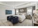 Luxurious primary bedroom with a tray ceiling, elegant chandelier, and stylish decor at 445 Olivia Crossing Ct # 22, Four Oaks, NC 27524
